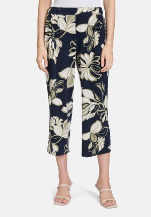 Marineblau gemusterte, verkürzte Hosen mit einem elastischen Bund, die große cremefarbene und olivgrüne botanische Drucke sowie eine weiche, glatte Textur aufweisen.