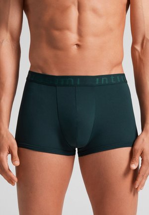 Dunkelgrüne Boxershorts mit einem weichen elastischen Taillenbund und dezentem Branding. Das Material wirkt glatt und hat eine körpernahe Passform.