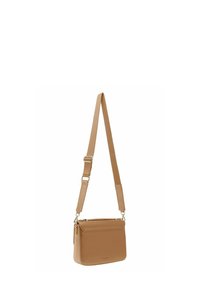 Sac bandoulière beige en matériau synthétique lisse, équipé d'une sangle réglable, d'une fermeture zippée sur le dessus et d'une poche à l'avant.