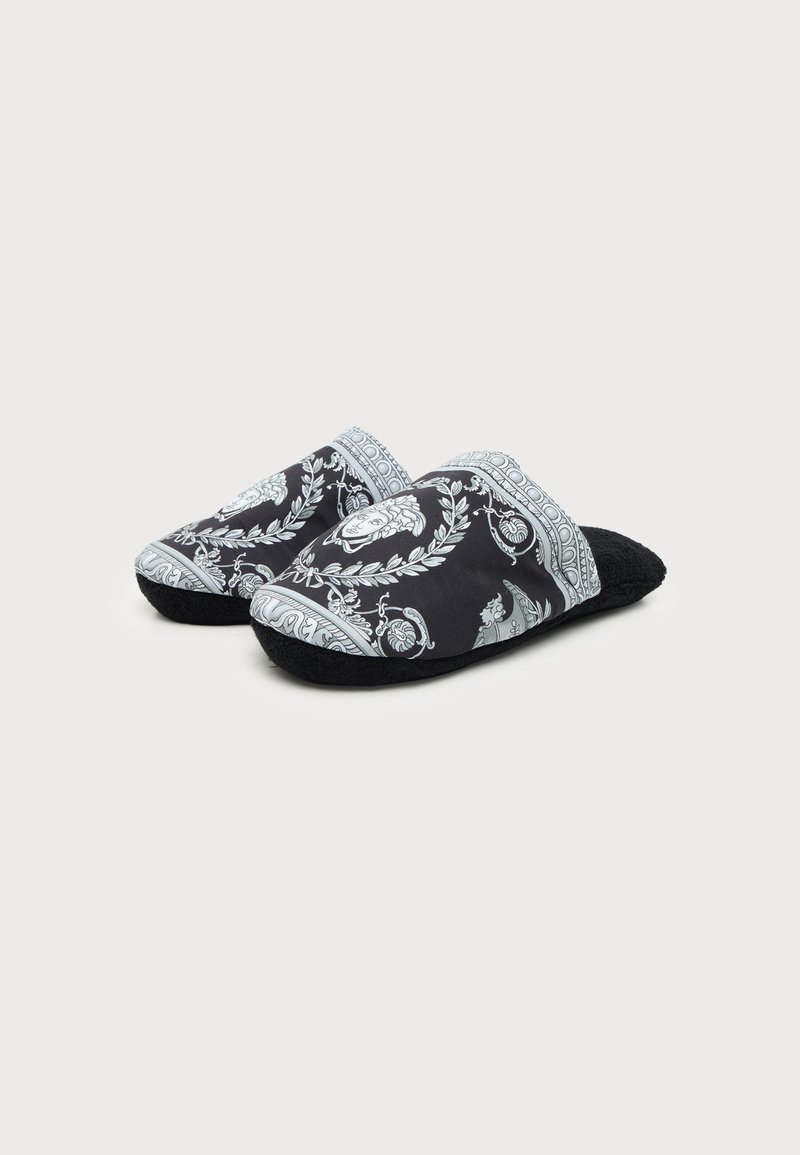 Pair of black slip-on slippers with white intricate baroque-style patterns and soft textured soles, shown against plain background.