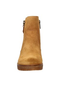Tan suede ankle boot with a rounded toe, side zipper, and rubber sole. Smooth texture and minimal stitching detail.