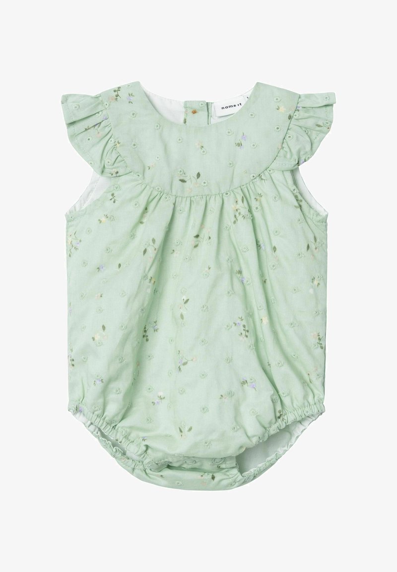 Indumento in cotone verde chiaro con maniche a volant, ricami floreali e fondo elasticizzato. Presenta una chiusura con bottoni sul retro e una texture morbida.