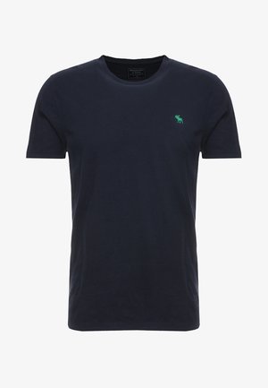 T-shirt in cotone blu navy con scollo rotondo e maniche corte, con un piccolo logo verde sul petto. Tessuto liscio, vestibilità classica.