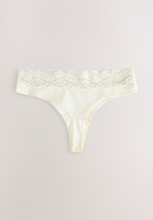 Lace-trimmed thong underwear in light cream color. Features a soft fabric, delicate lace waistband, and minimal rear coverage.