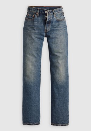 Blå denimjeans med rak bendesign, med synliga sömmar, dragkedja och fem fickor. Bleka områden ger textur.