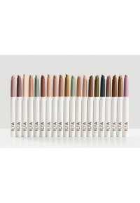 Set of twenty lip crayons in various shades from nude to dark brown, including green and pink, with white tubes labeled ILIA.