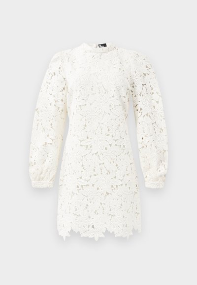Witte kanten jurk met bloemenpatronen, lange pofmouwen, een hoge halslijn en een gegolfde zoom voor extra detail.