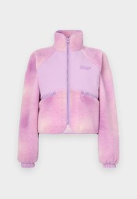 Fleece striukė šviesiai violetinėje spalvoje su gradientu, užtrauktuku priekyje, aukštu apykakle ir raukšlėtomis rankogaliais. Papuošta dviem užtrauktukais uždarytomis kišenėmis. Minkšta tekstūra.