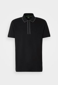 Polo noir à manches courtes avec fermeture éclair à l'avant, col pointu avec bordure grise, et logo subtil de la marque sur la poitrine.