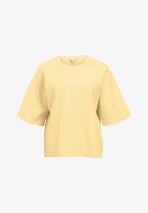 Sweatshirt ample jaune pâle à manches courtes avec encolure ronde et coutures raglan, en tissu doux.