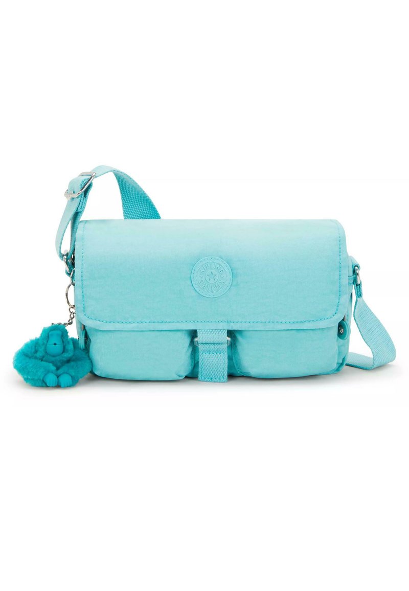 Turquoise crossbody bag made of soft fabric. Features a flap closure, adjustable strap, and a fuzzy gorilla keychain attached.