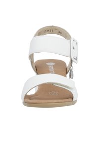 Open-toe white sandal with two wide straps, a square buckle on the ankle strap, and a light brown insole. Flat sole with subtle texture.