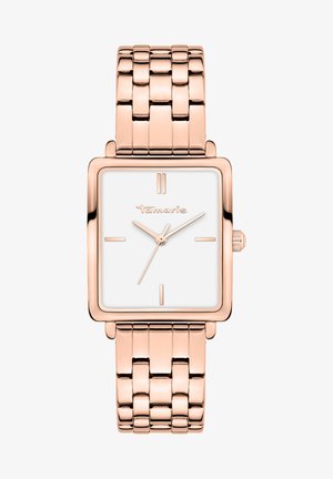 Montre rectangulaire en or rose avec un cadran blanc, marqueurs d'heure minimalistes et un bracelet en métal maillé. Le nom de la marque "Tamaris" apparaît sur le cadran.