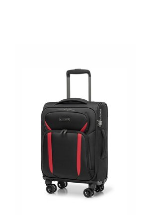 Valise noire avec accents rouges, tissu texturé, quatre roues, compartiments à double fermeture éclair et une poignée télescopique.