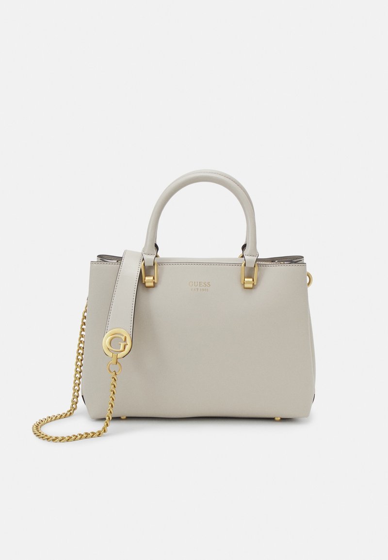 Light gray structured handbag with double handles, gold hardware, chain strap, and embossed brand name "Guess" on the front.