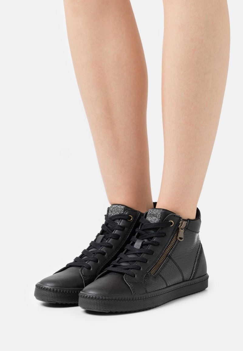 Black high-top sneakers made of textured leather, featuring a zipper on the side and a glitter accent on the tongue. Rubber outsole.