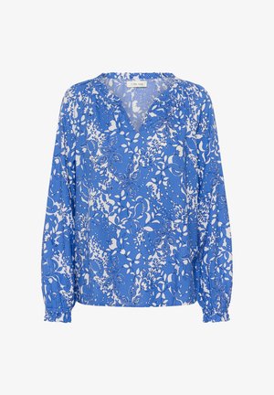 Sinise lillemustriga pluus, millel on pikad varrukad, V-kaelus ja kogutud varrukaotsad. Pehmel kangal on kontrastsed valged lillemotiivid.