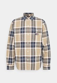 Chemise à manches longues boutonnée avec motif à carreaux beige, marine, blanc et olive, poches poitrine et petit logo de marque sur la poche gauche.