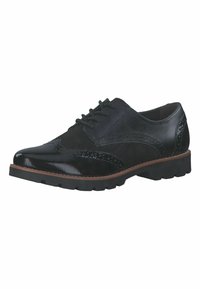 Chaussures noires à lacets avec une combinaison de cuir poli et de daim, présentant des détails brogue, un bout arrondi et une semelle texturée.