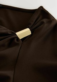 Brown fabric with a smooth texture, features a gold metallic accent at the center, creating a knotted detail.