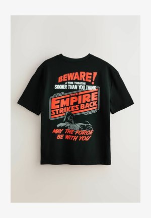 Black cotton T-shirt featuring a graphic print with red and white text. Design includes "Beware!" and "The Empire Strikes Back" with an image of a character.