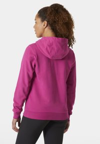 Sudadera con capucha fucsia, con cordón en la capucha, mangas largas y puños de canalé, hecha de una tela suave. Textura lisa y corte casual.