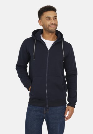 Marine blauwe zip-up hoodie gemaakt van zachte stof, met een capuchon met trekkoord, voorkeurszakken en ribbels bij de manchetten en onderkant.