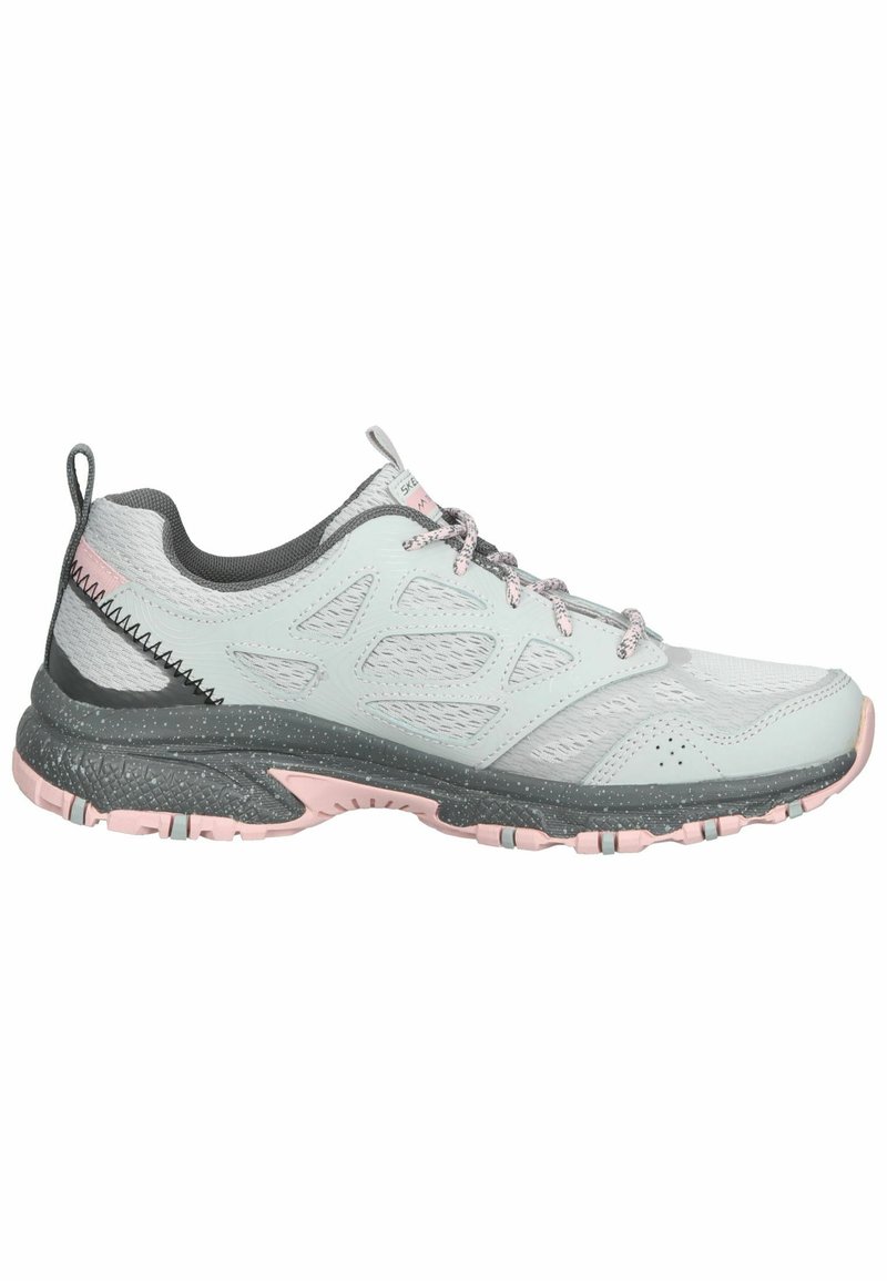 Zapatilla atlética ligera en verde menta con acentos en rosa, parte superior de malla y suela gris texturizada con patrones de agarre para tracción.