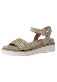 Beige Sandale mit gewebtem Texturriemen, verstellbarem Knöchelband und gepolsterter Sohle auf einer weißen Plattform. Verfügt über eine geriffelte Außensohle für besseren Halt.