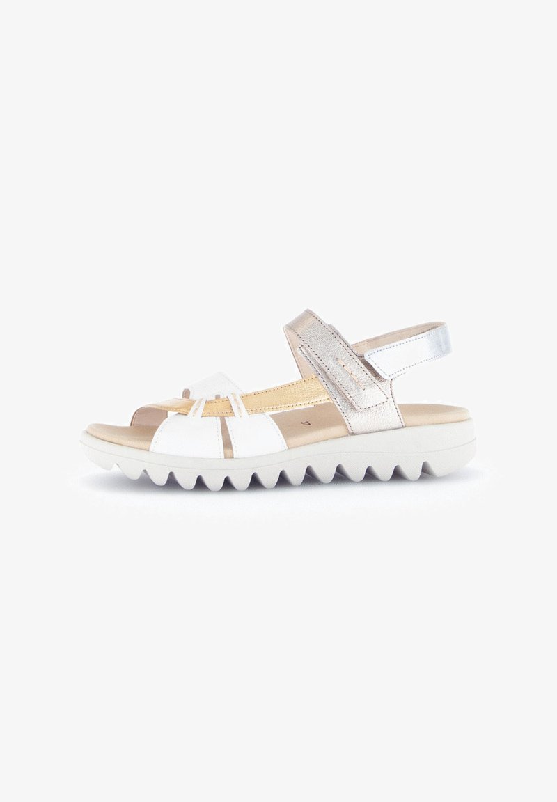 White and metallic silver sandal featuring a textured footbed, open design, adjustable strap, and a white ridged sole for traction.