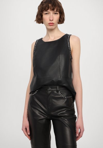 Black leather sleeveless top featuring silver studs along the shoulders, paired with black leather pants. Smooth texture and fitted design.