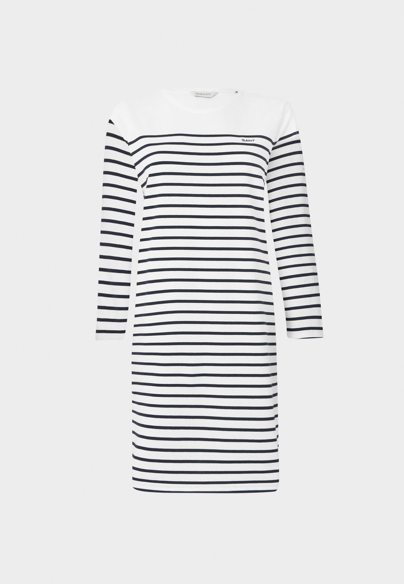 Pasiasta sukienka w białym i granatowym kolorze, długie rękawy, okrągły dekolt i długość do kolan; posiada subtelne logo po lewej stronie u góry.