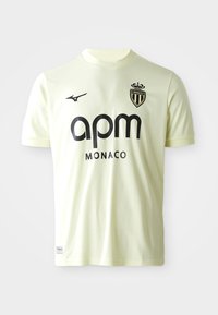 Svetložltý futbalový dres vyrobený z priedušného materiálu. Obsahuje okrúly golier, krátke rukávy a čierne logá a text vpredu.