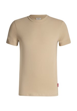 T-shirt beige à manches courtes en coton doux. Il présente un col rond côtelé et une petite étiquette logo rouge sur le côté gauche.