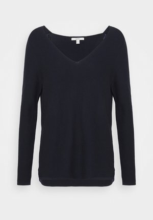 Pull noir à manches longues avec col en V, tissu légèrement texturé et ourlet droit sur un fond uni.