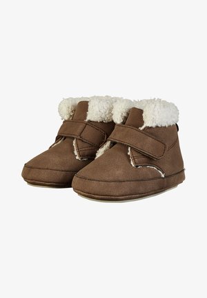 Brown baby booties with soft white fleece lining and a single Velcro strap across the front, designed for warmth and comfort.