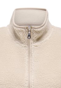 Giacca in pile beige con collo alto e zip frontale, caratterizzata da una superficie testurizzata e un tessuto morbido e peloso.