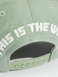 Light green corduroy cap featuring white embroidered text "THIS IS THE WAY" on the back, with a plastic snapback closure.