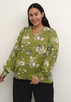 Grüne Bluse mit Blumenmuster, V-Ausschnitt, langen Puffärmeln und gerafften Bündchen. Auffällige rosa und weiße Blumenmuster mit dunklen Akzenten.