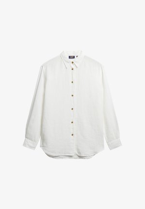 Chemise blanche à manches longues en tissu texturé, avec un col classique, sept boutons marron à l'avant et un ourlet arrondi.