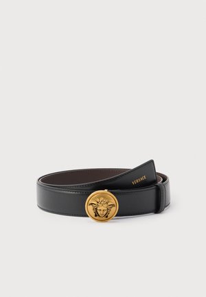 Black leather belt with round gold buckle featuring Medusa head, Versace logo embossed on inner strap end.