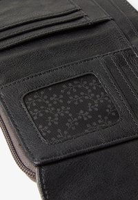 Black leather wallet featuring multiple card slots and a transparent ID window. Textured finish with precise stitching detail.