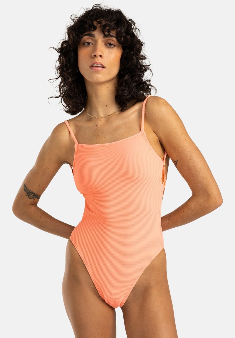 Maillot de bain une pièce en texture côtelée, doté de bretelles fines et d'une couleur corail vive. Conçu avec un dos décolleté et une coupe haute sur les jambes.