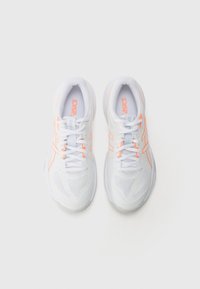White athletic shoes with mesh and synthetic material, featuring neon orange accents, lace-up closure, and a textured rubber sole.