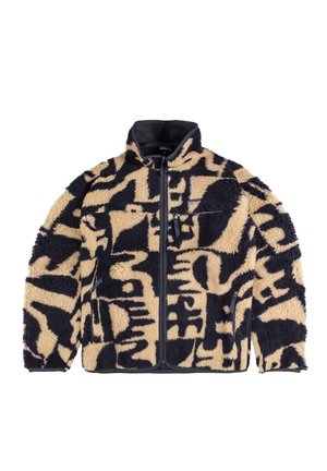 Giacca in pile beige e blu marin, con un motivo testurizzato. Chiusura con zip, colletto alto e tasche laterali con rifiniture a contrasto.