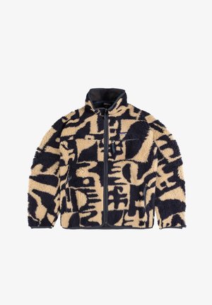 Giacca in pile beige e blu marin, con un motivo testurizzato. Chiusura con zip, colletto alto e tasche laterali con rifiniture a contrasto.