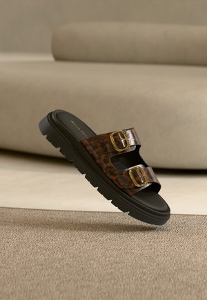 Braune Leopardenmuster-Pantoletten mit zwei goldenen Schnallen, einer schwarzen Gummisohle und einem glatten, kunstlederbezogenen Obermaterial.