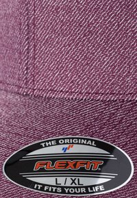 Flexfit-cap i en strukturert burgunderfarge. Har en buet skjerm og et svart ovalt merke som viser "FLEXFIT L/XL" og "THE ORIGINAL."