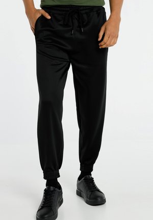 JOGGER NAUGHTY GRÖSSE IN ZOLL - Tracksuit bottoms - schwarz