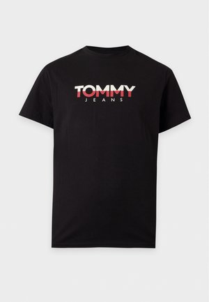 T-shirt noir à manches courtes et à col rond, avec le logo TOMMY JEANS sur la poitrine, sur un fond uni.
